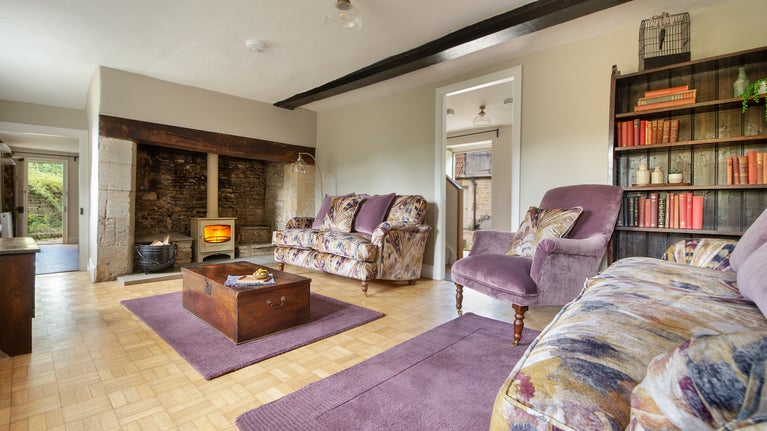 The sitting room with woodburner in the original inglenook at 20 Church Street, Wiltshire